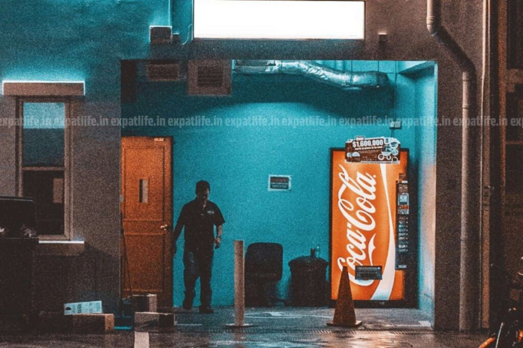 Vending machine of Coca-Cola where employees refill the cola bottles and other products periodically.